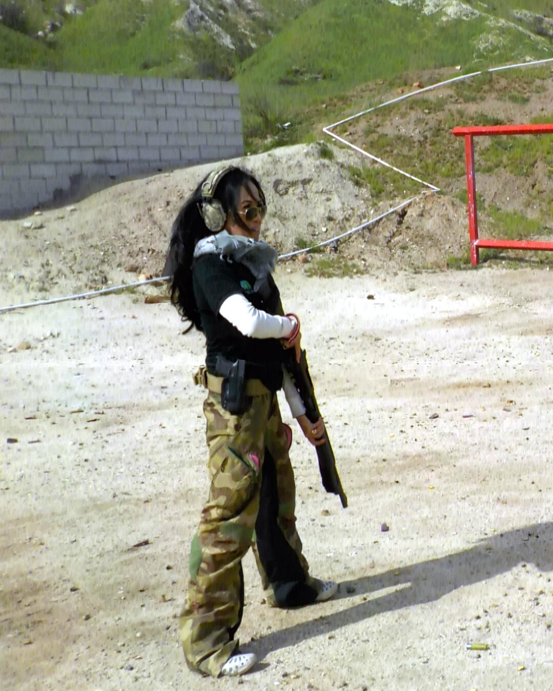 Nicky Dare conducting tactical shotgun instruction during a live group training session at an outdoor range.